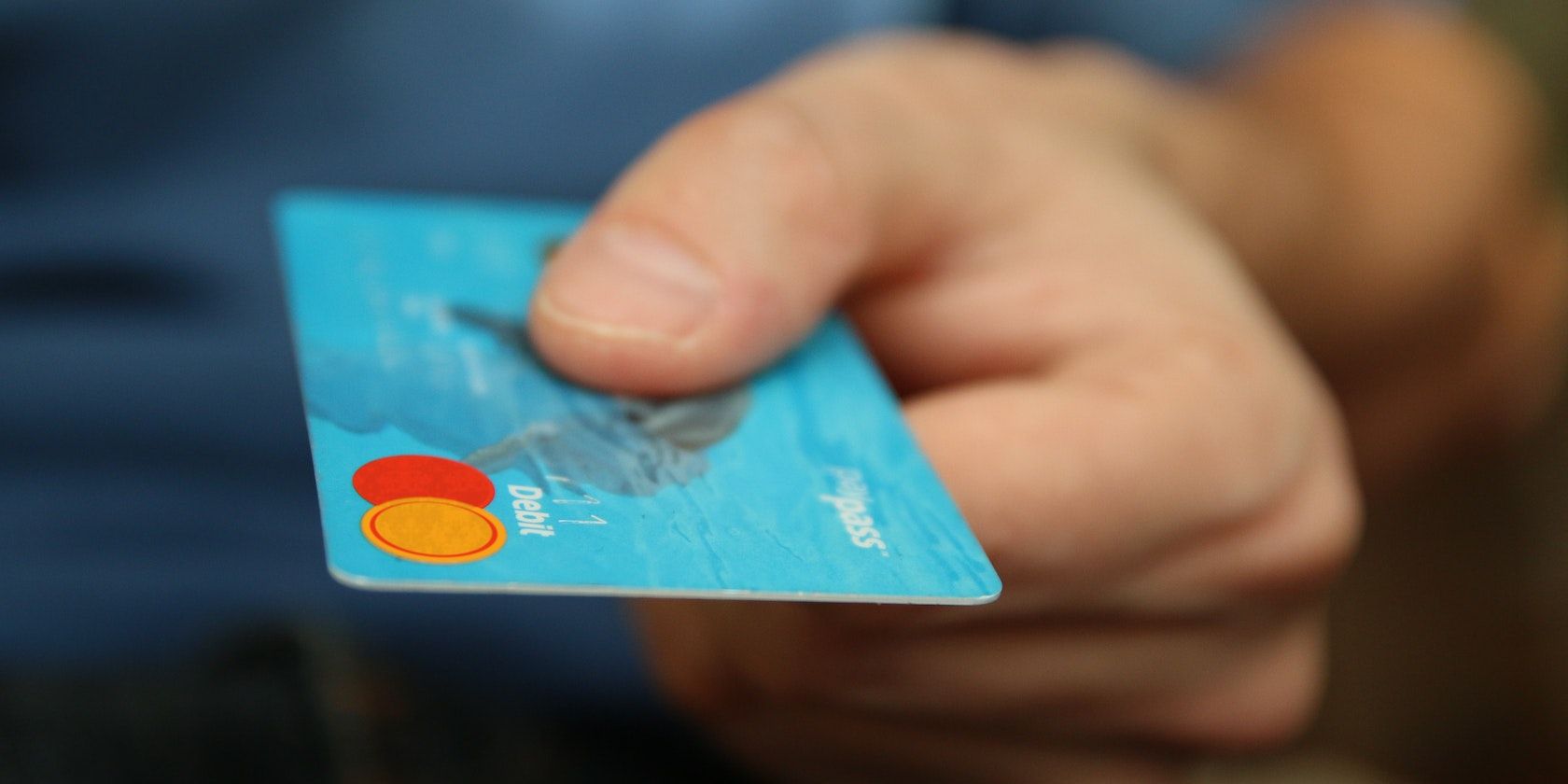 Person holding debit card
