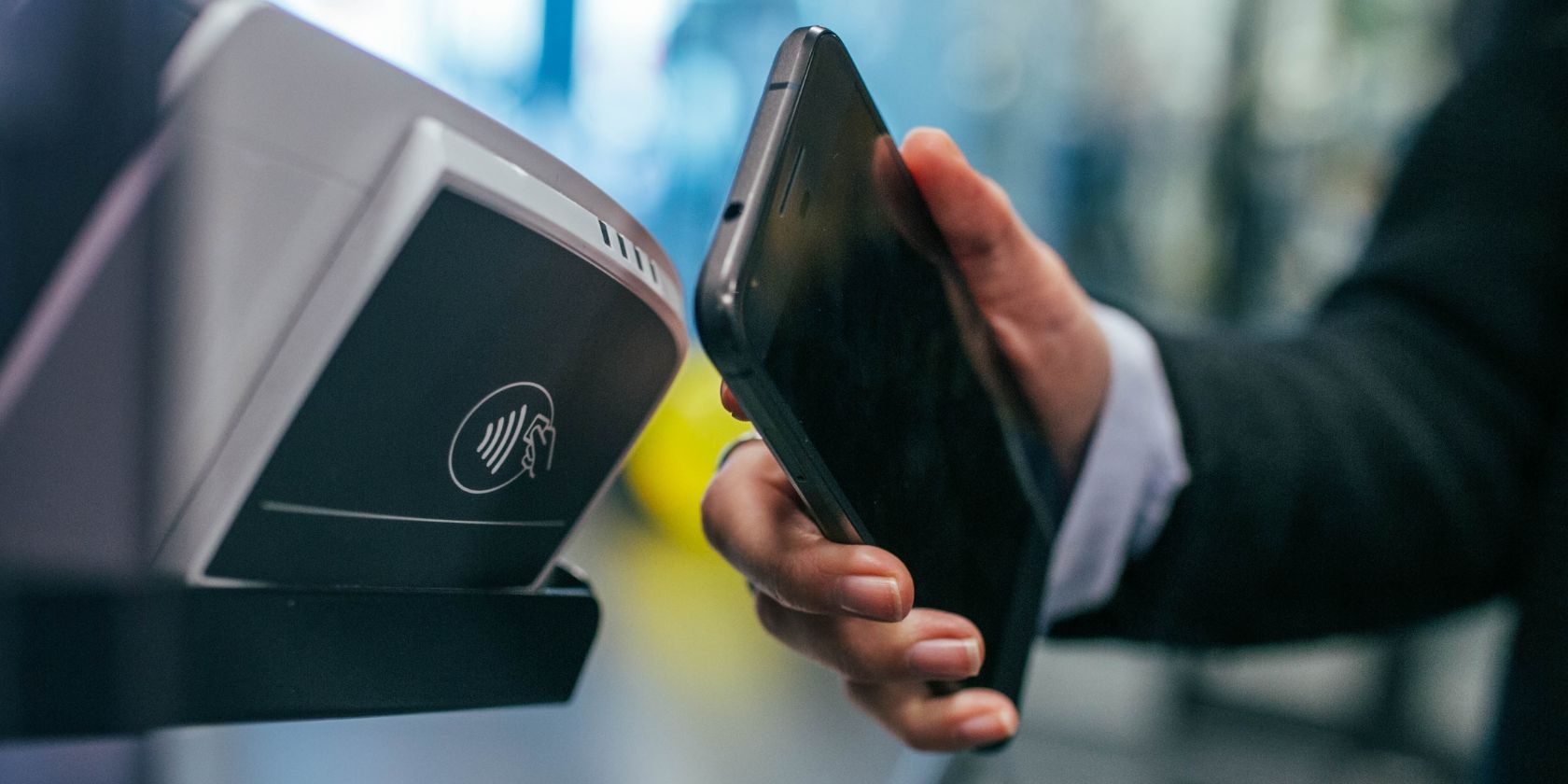 person using contactless payment with smartphone