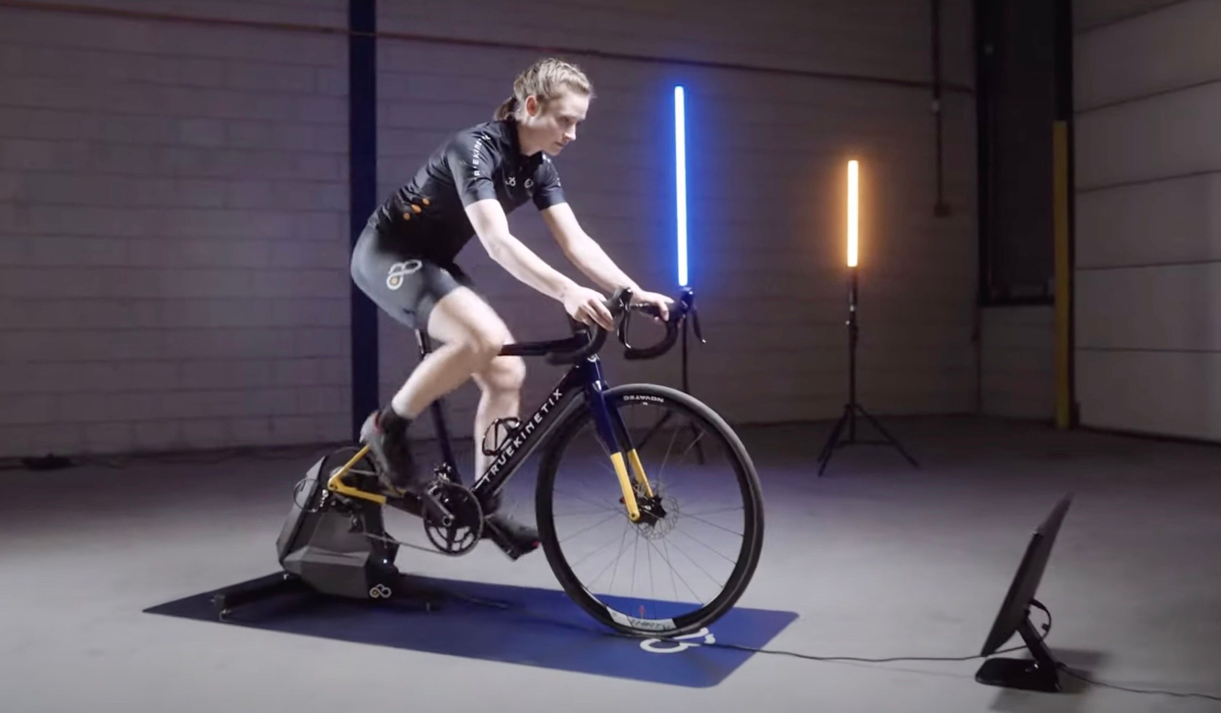 Woman riding the truetrainer cycling device