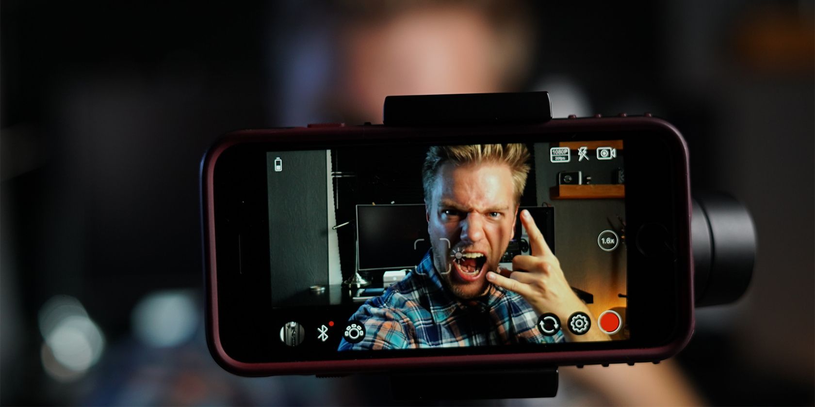 Image of a phone camera with man taking photo.