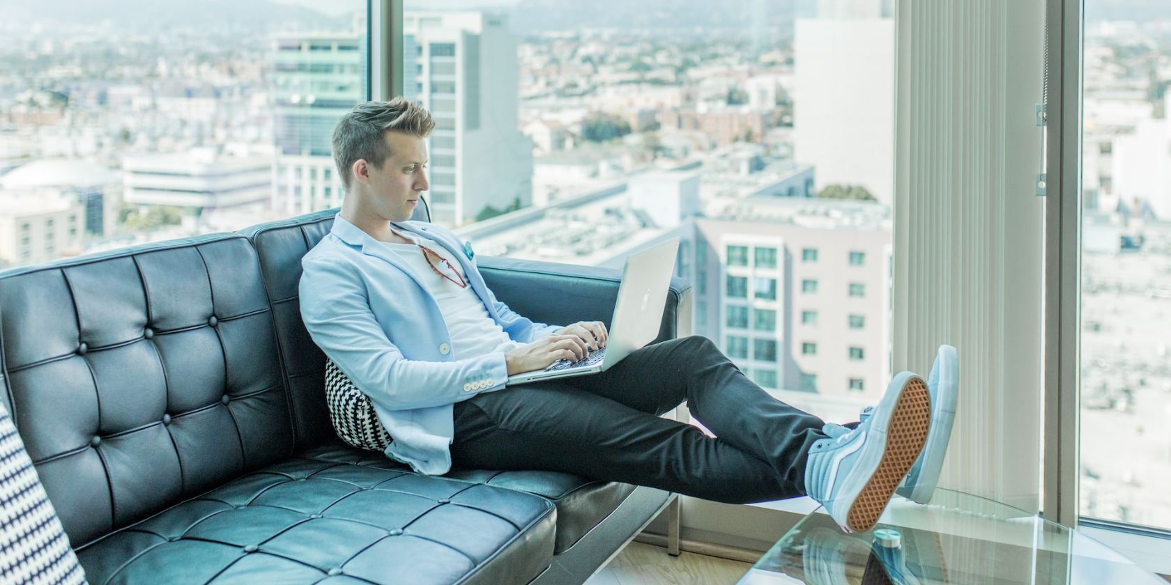 a man sitting on sofa and working remotely