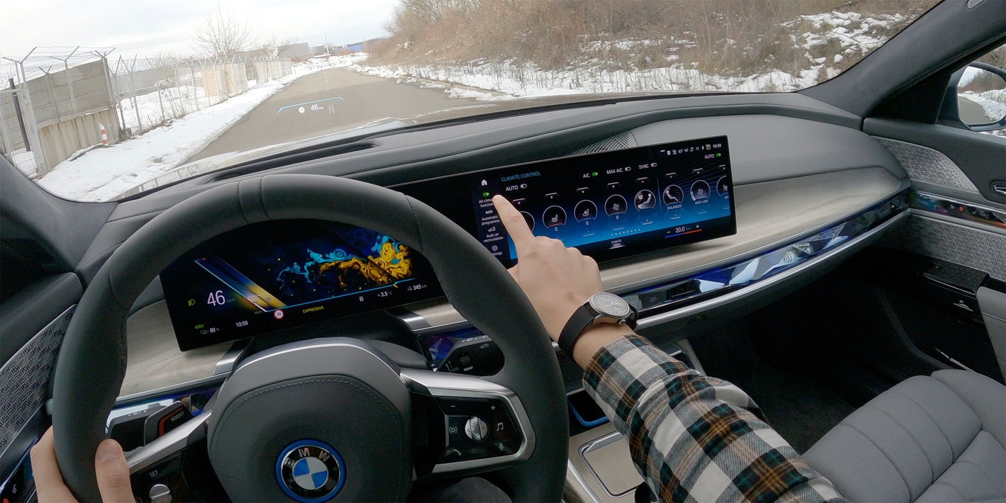 BMW i7 POV photo while driving and operating touchscreen infotainment