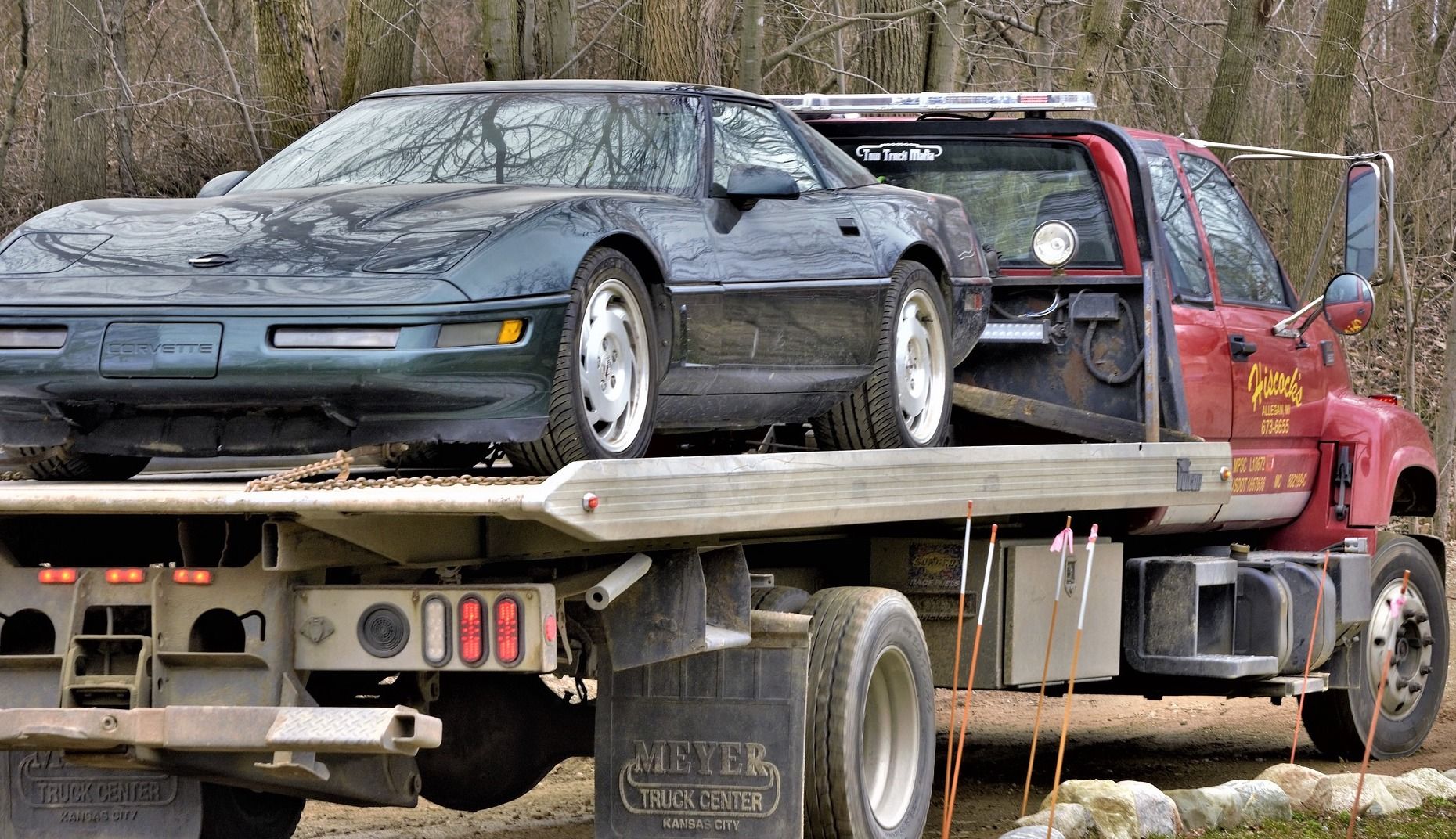 corvette on a flatbed tow truck
