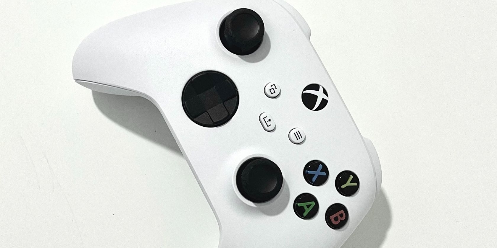 A photograph of a white Xbox Series X and Series S controller on its side