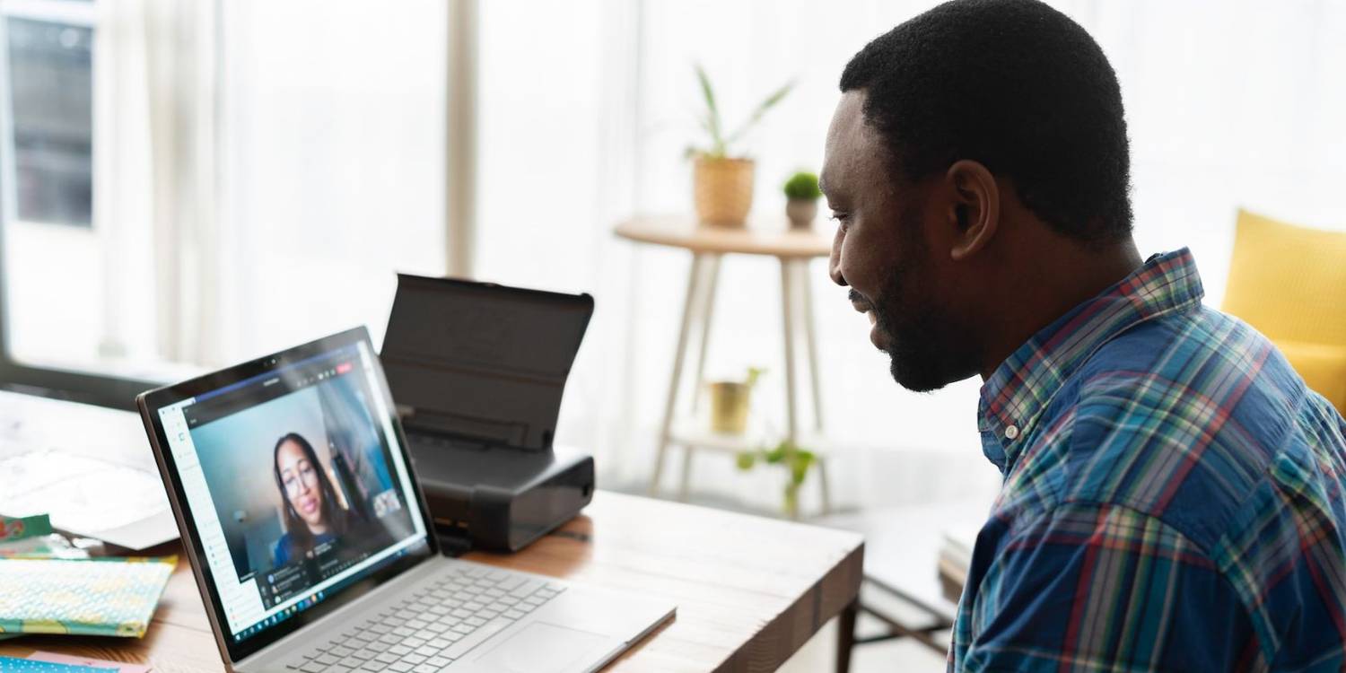 a man talking to an online mentor in a video meet