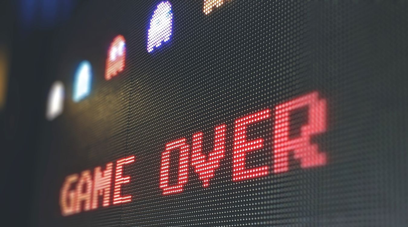A photograph showing the Game Over screen for Pac Man 