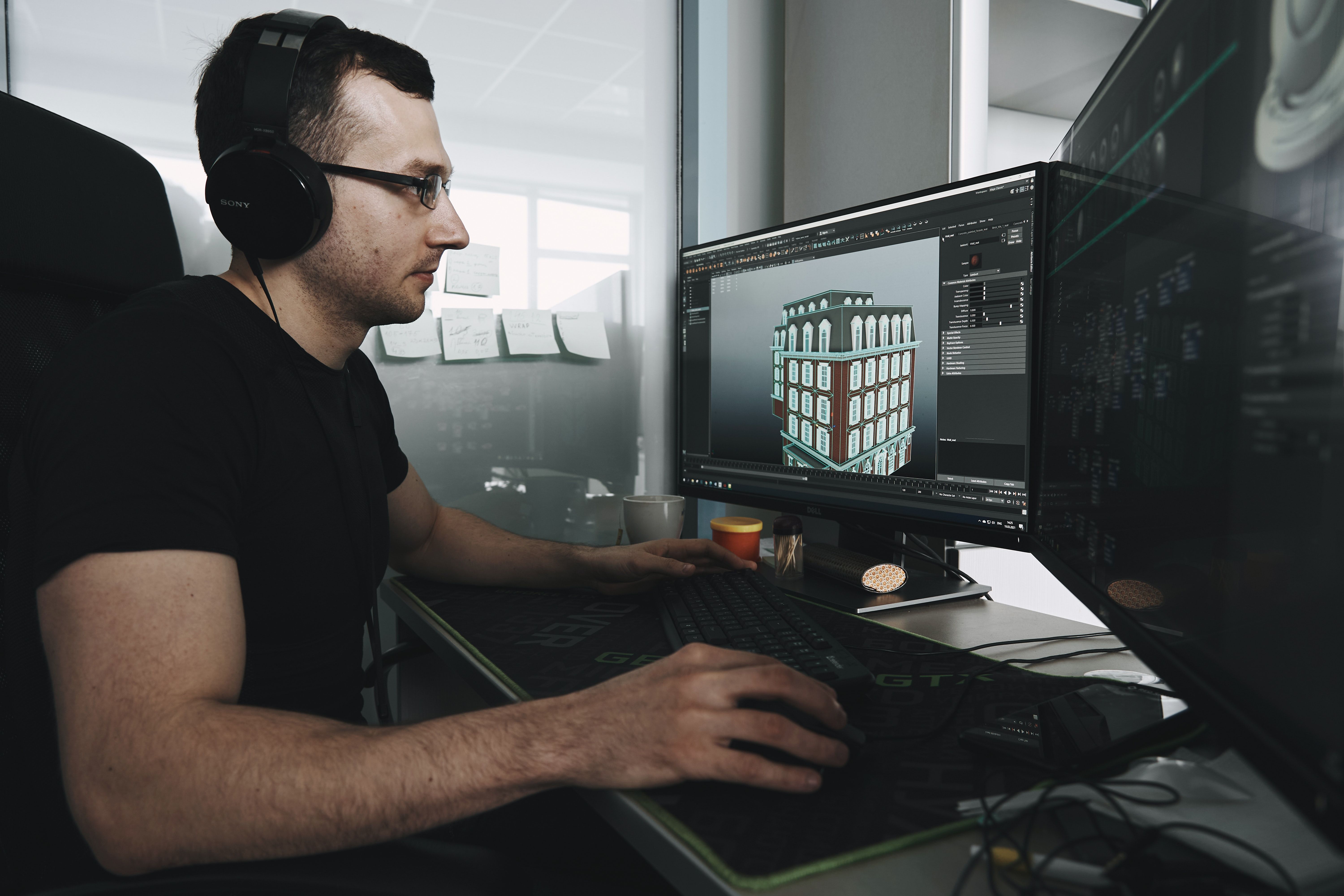 Person using 3D modeling software on a PC