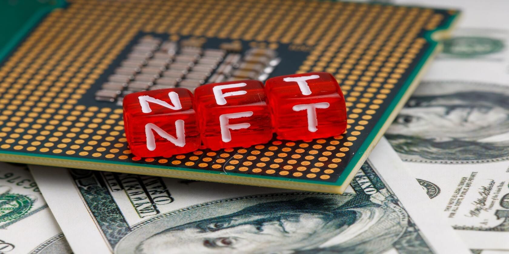 NFT inscription on cubes against the background of dollars