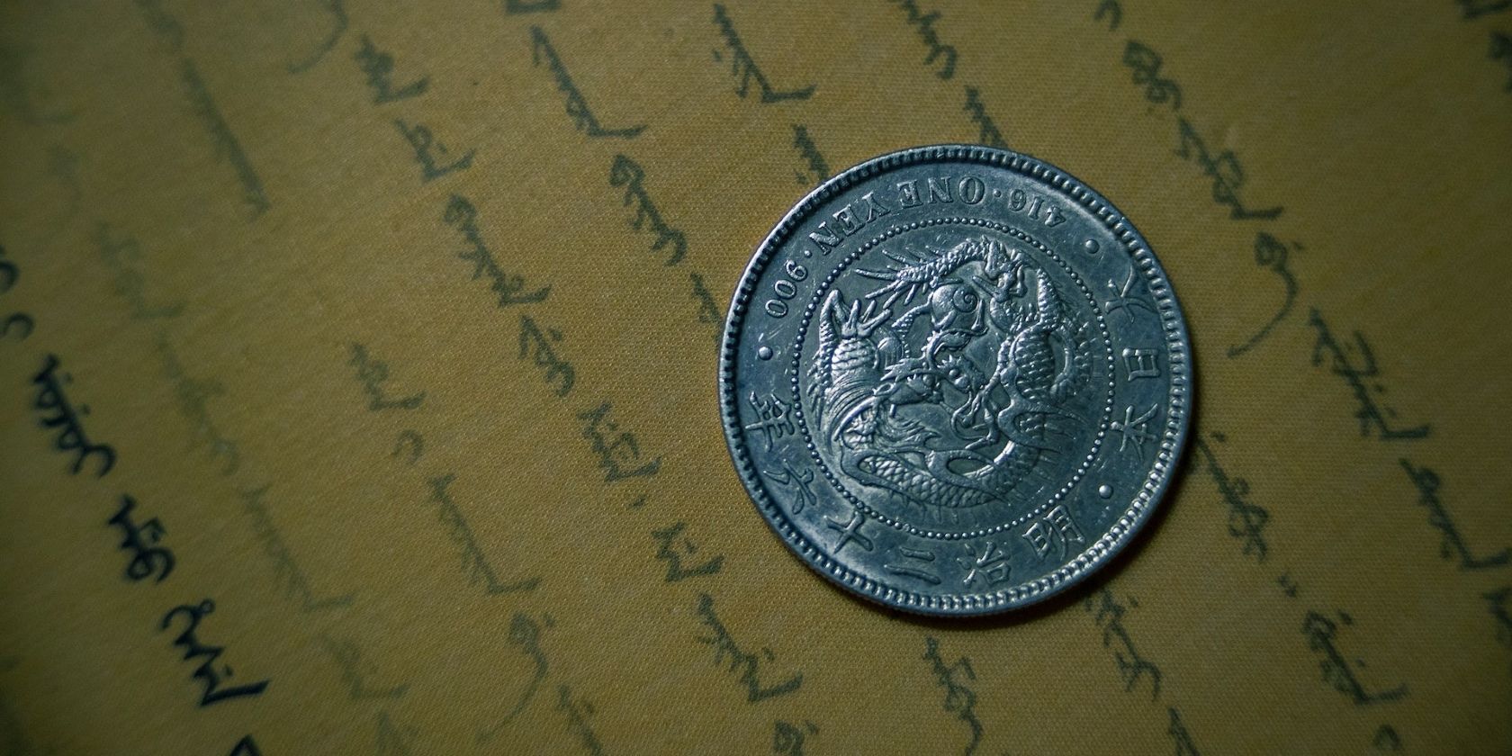 old coin sat on top of paper