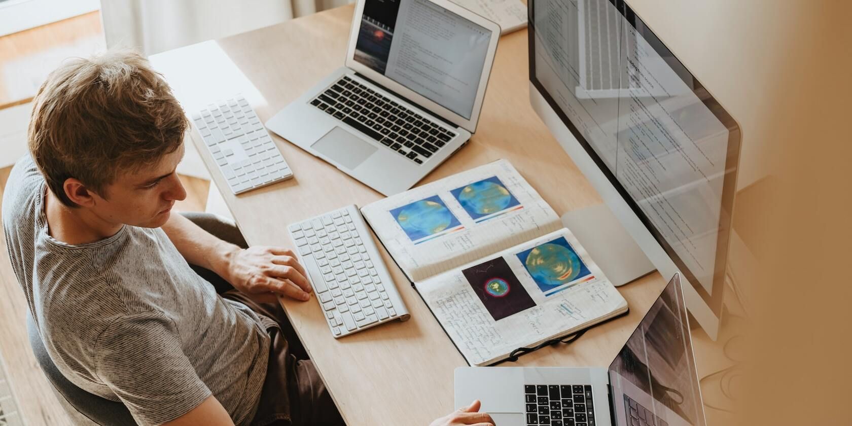 Man programming using three computers