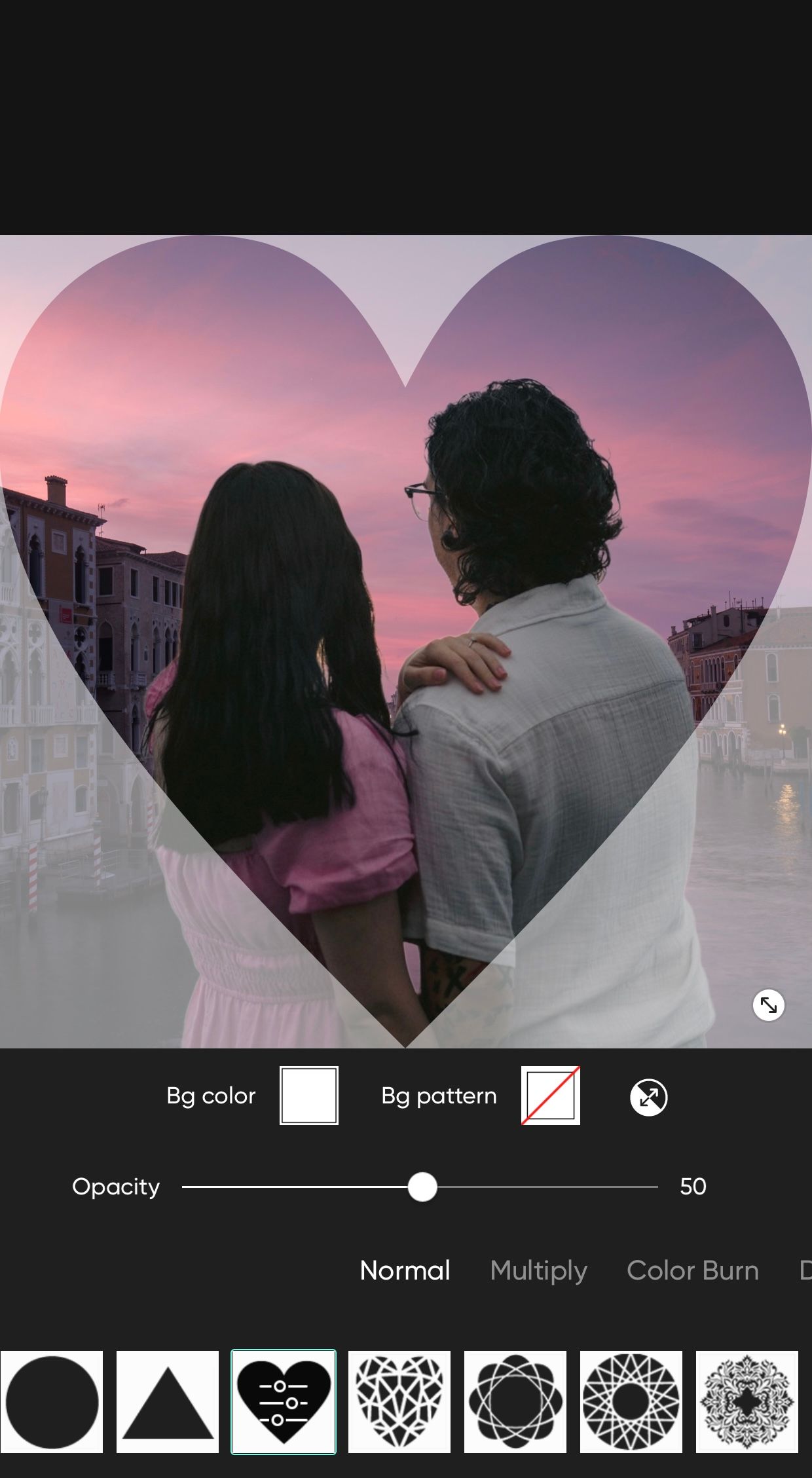 Heart framing couple overlooking Venetian sunset romantically