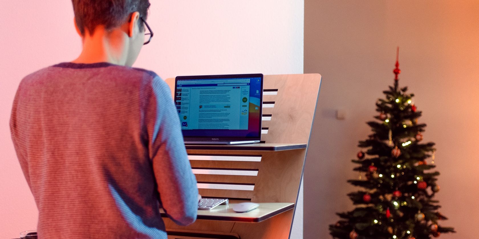 Man Using Standing Work Desk at Home