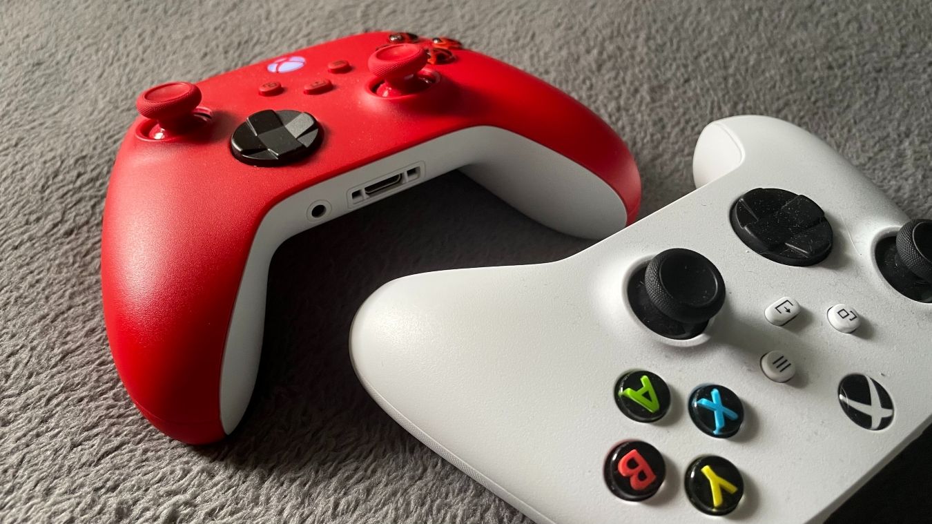 A photograph of a white and red Xbox Wireless Controller