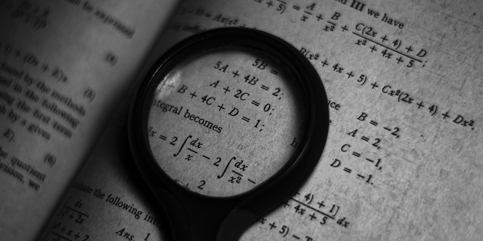 magnifying glass on maths book