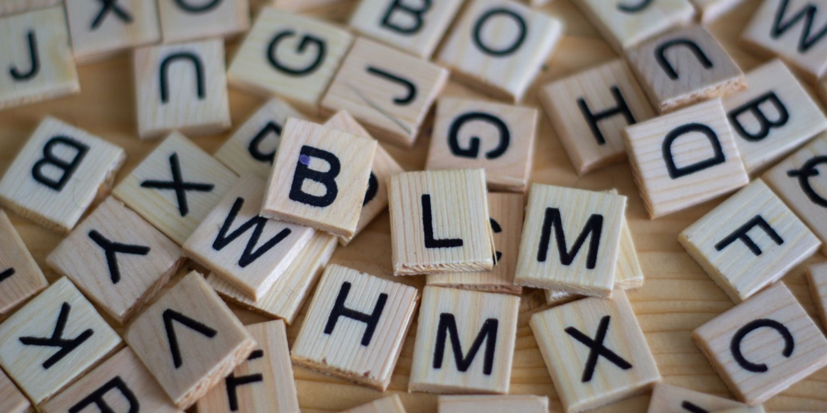 Word tiles spread on a wooden surface