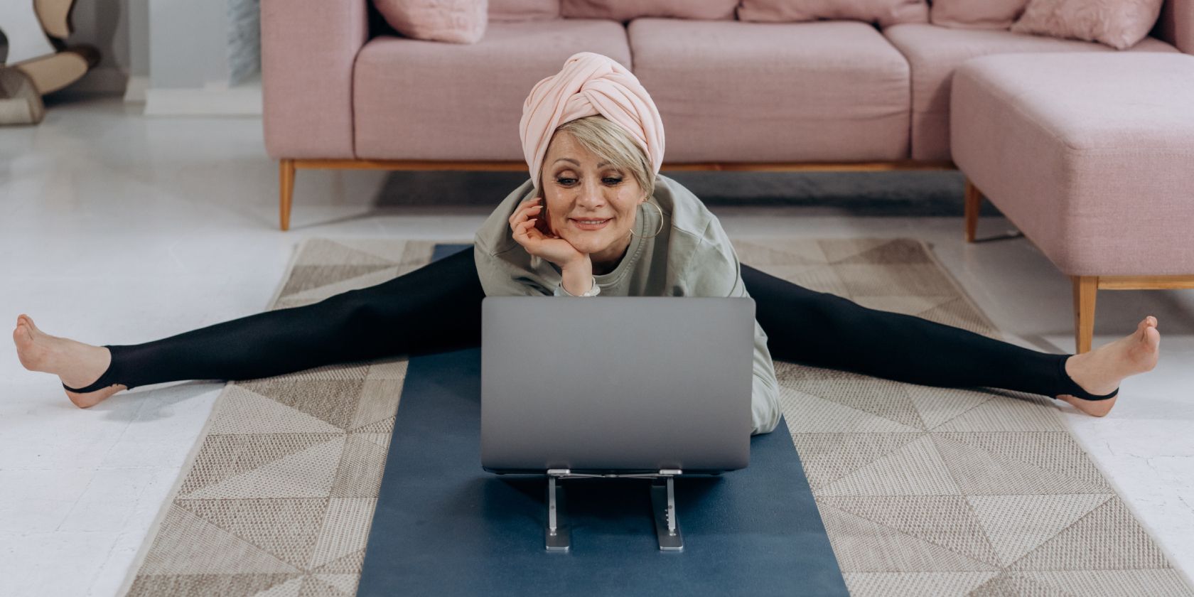 Senior doing yoga in front of a computer