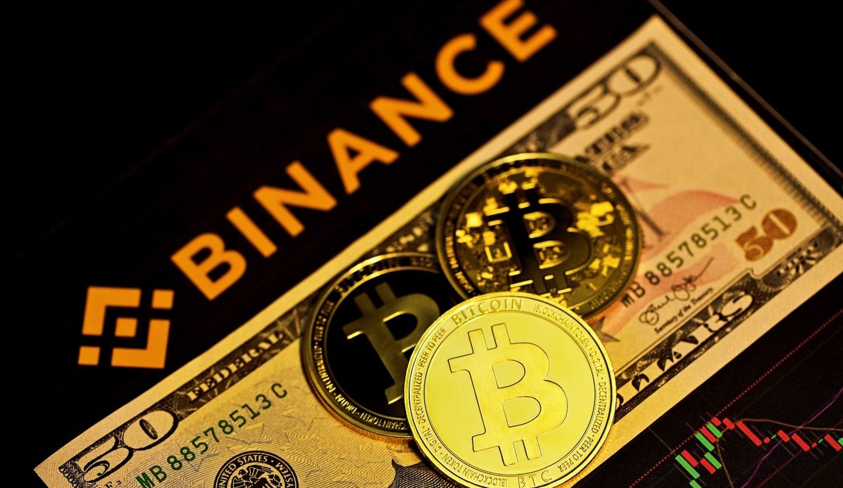 an image of Bitcoins, a $50 bill, and the Binance name and logo