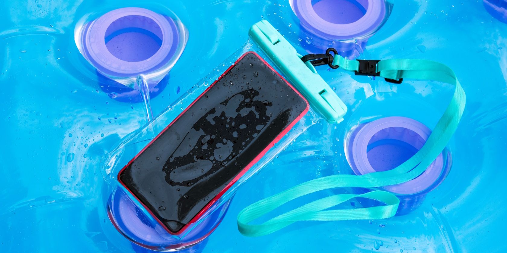 Phone in waterproof pouch floating in pool