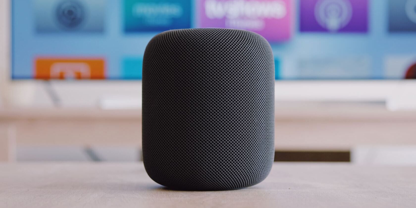 black Apple HomePod on a desk