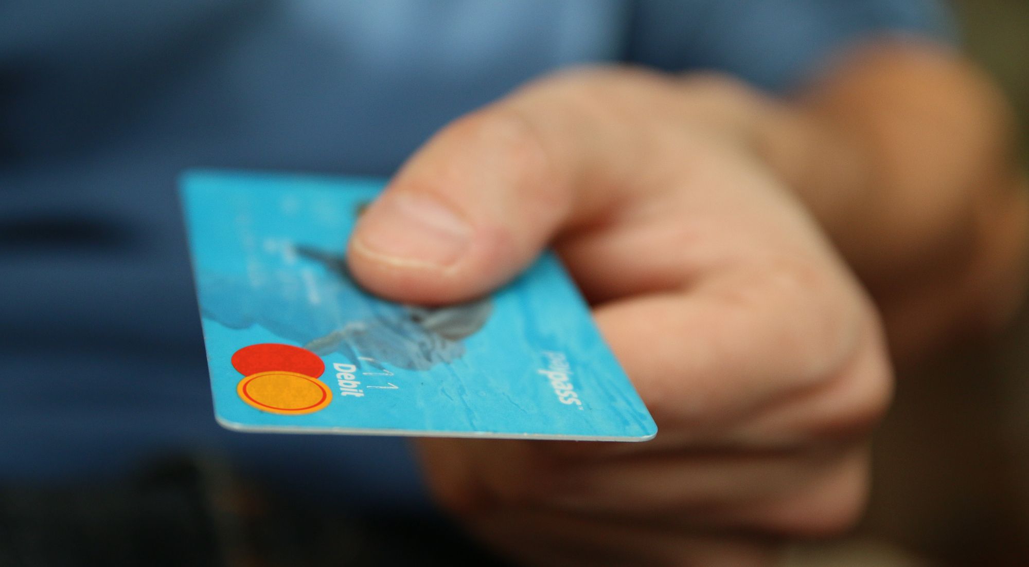 person holding blue payment card