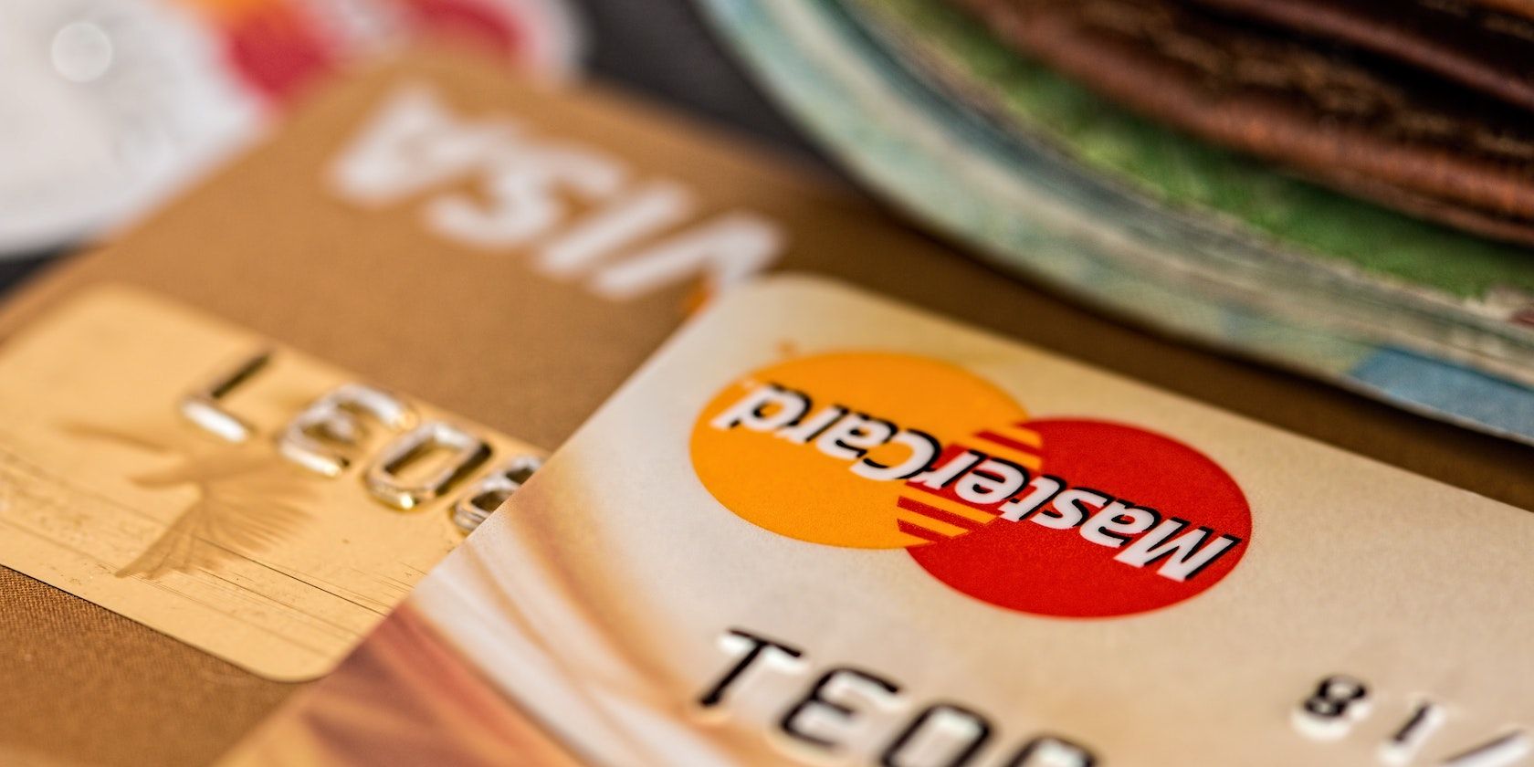 Close-up photo of two brown Mastercard cards