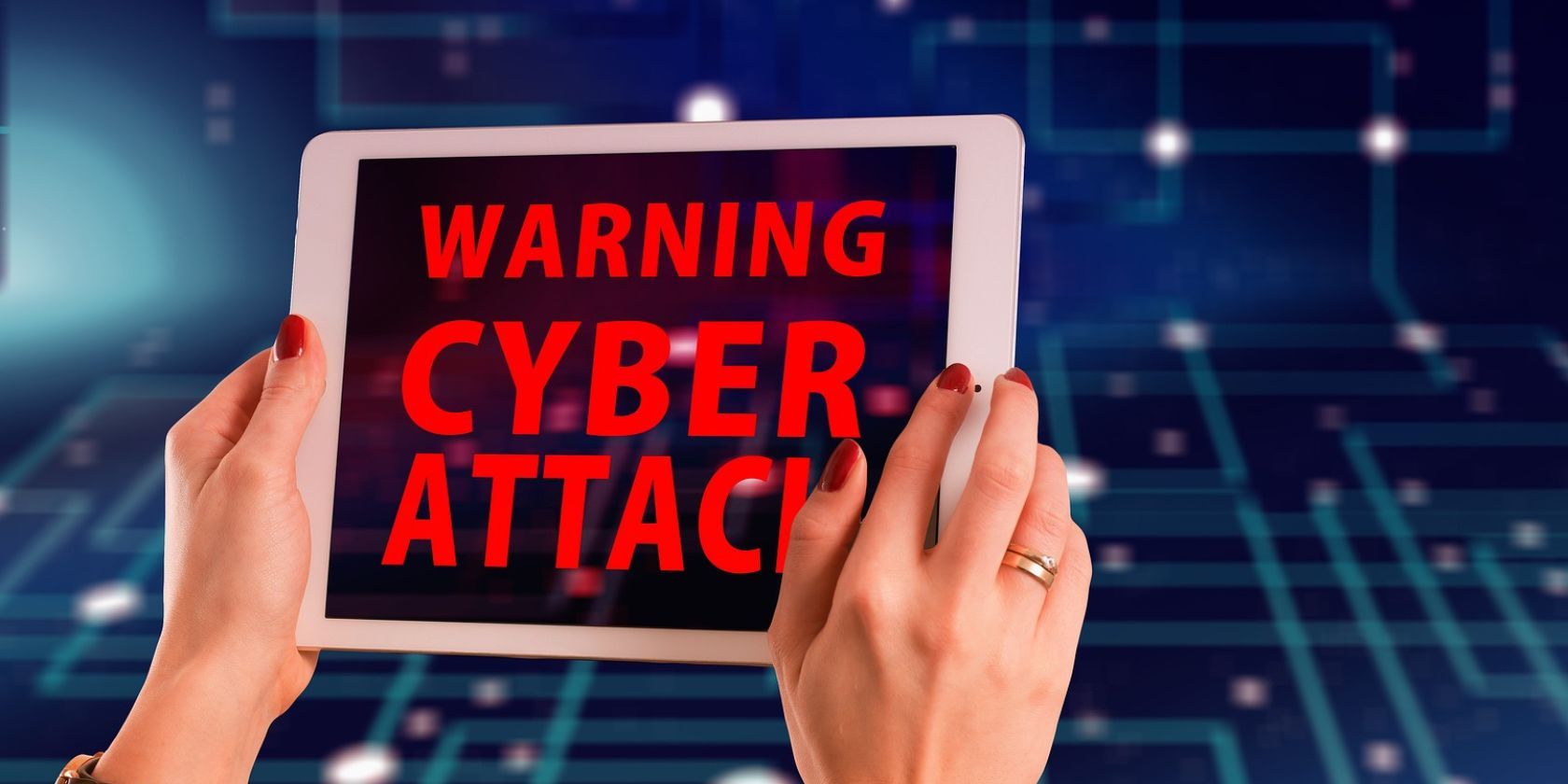 cyber attack alert on tablet and digital blue background