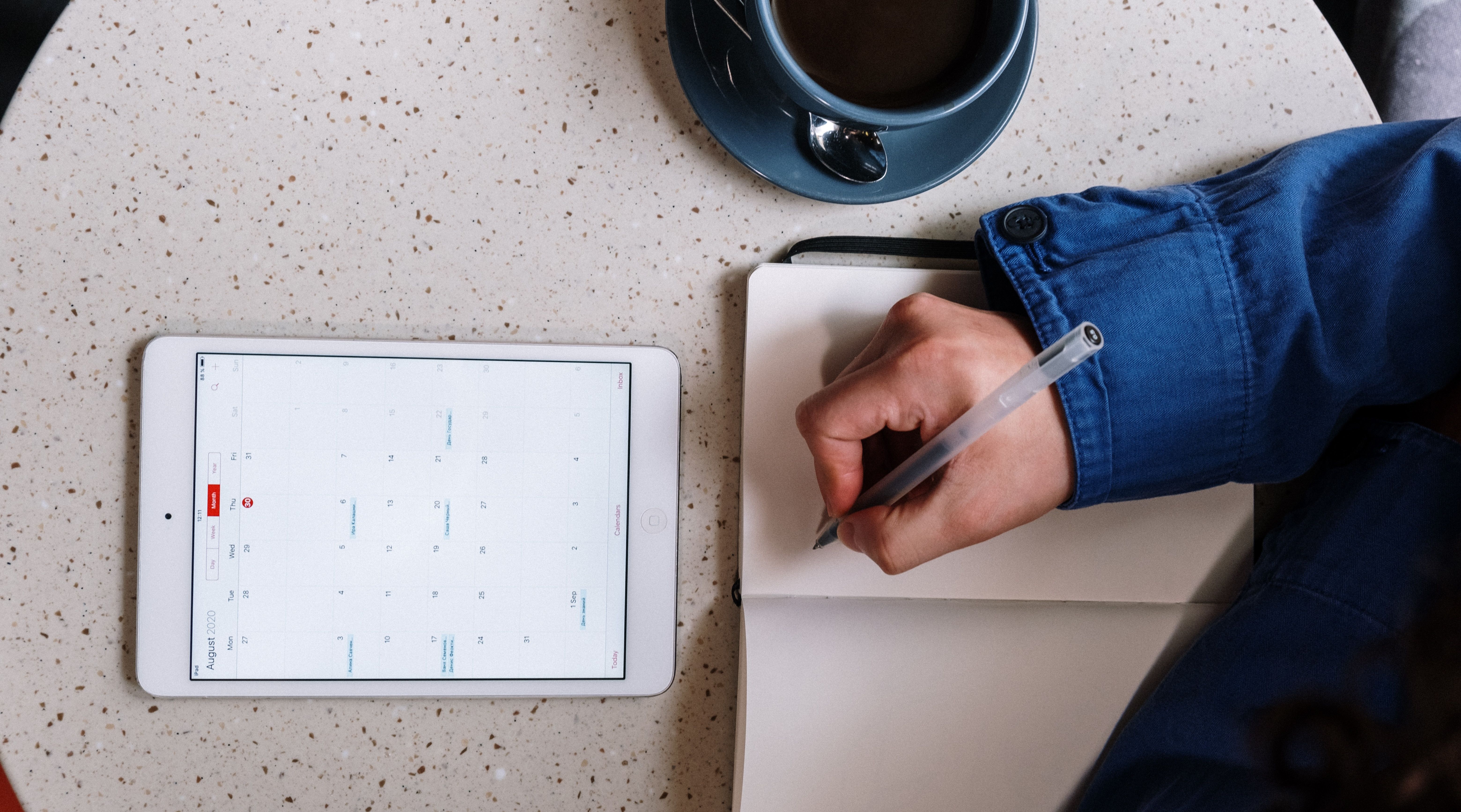 Digital calendar on table with coffee cup