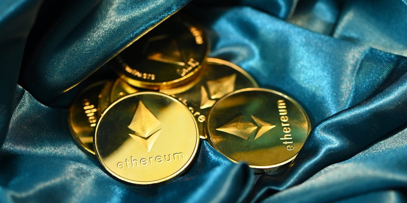 Ethereum coins on a blue fabric