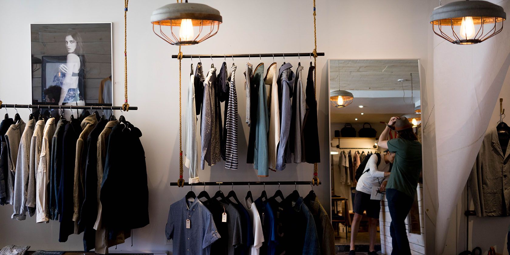 Interior of clothing store, with clothes on rail