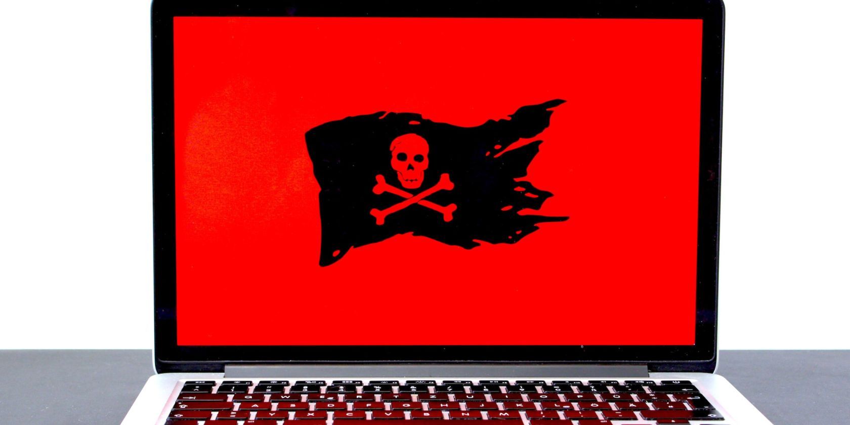 skull flag on red background on laptop screen