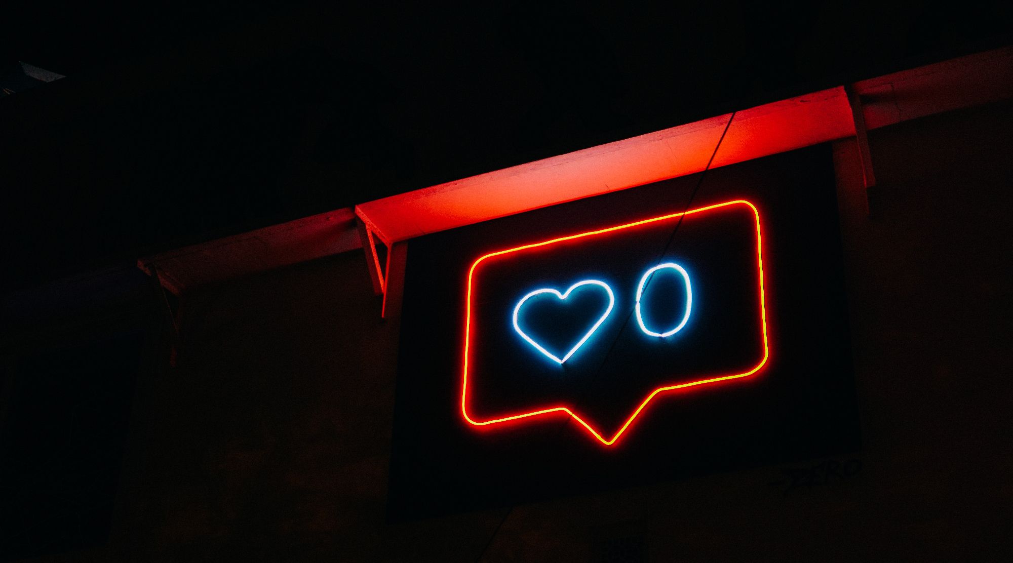 photo of neon social media like icon in dark room