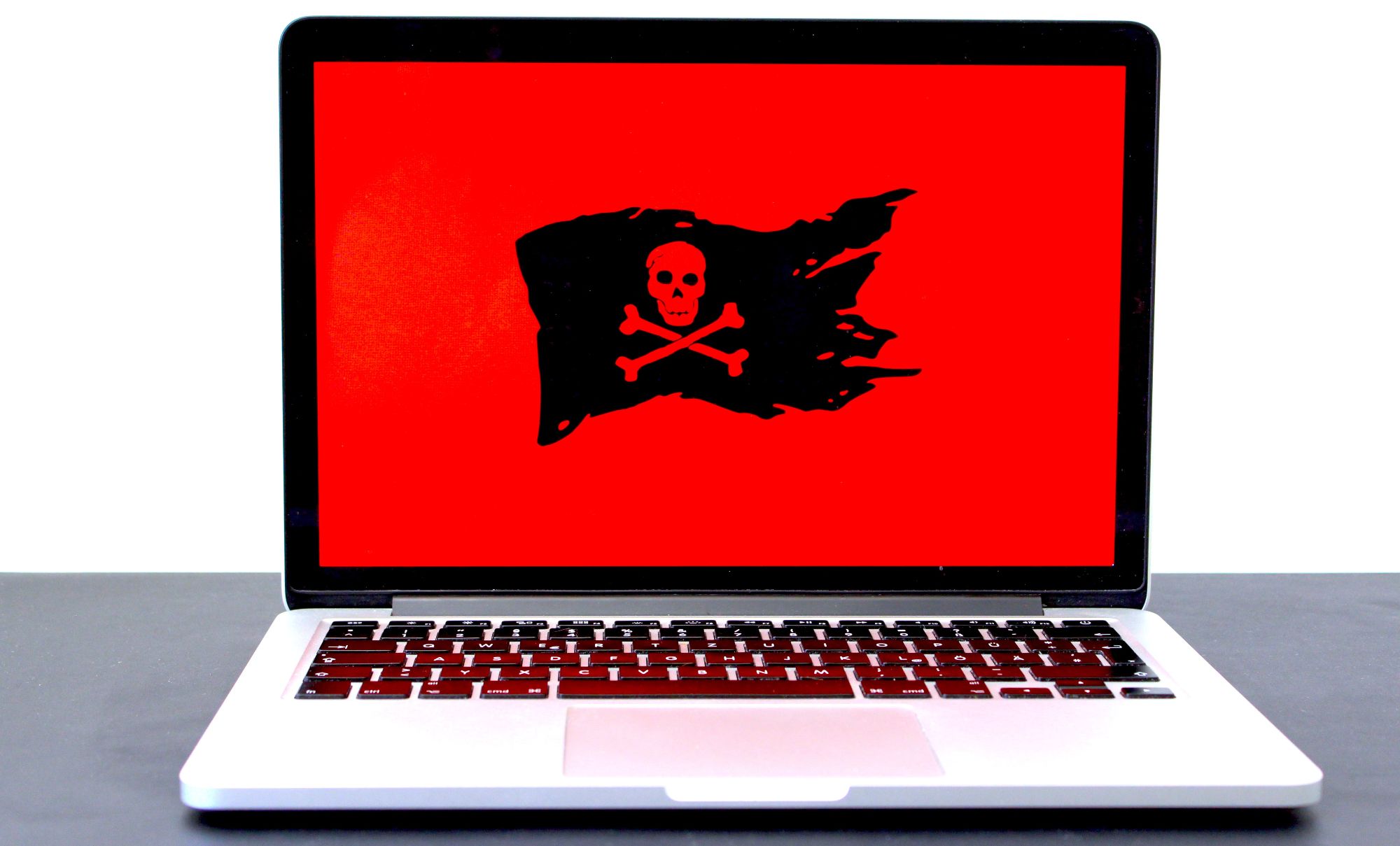 black skull and bones flag on laptop screen