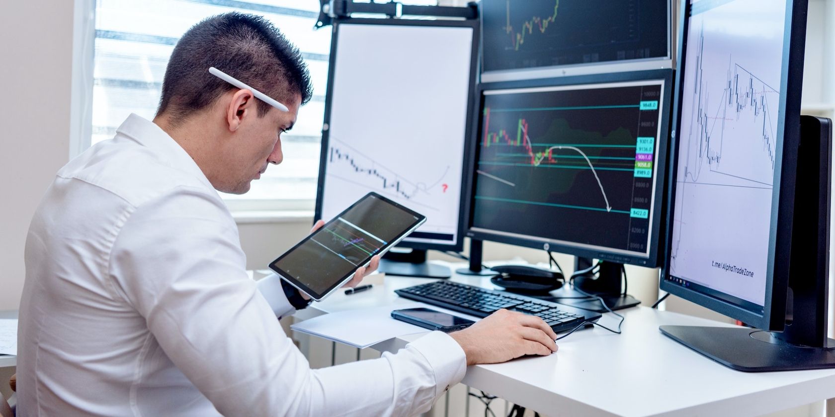 man sitting in front of chart with computers 