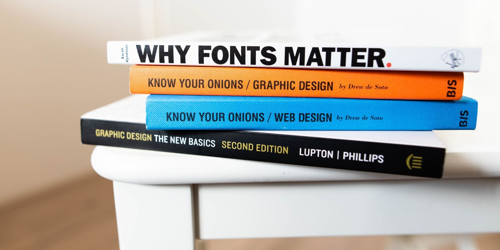 close up of four books on graphic and web design on a white table