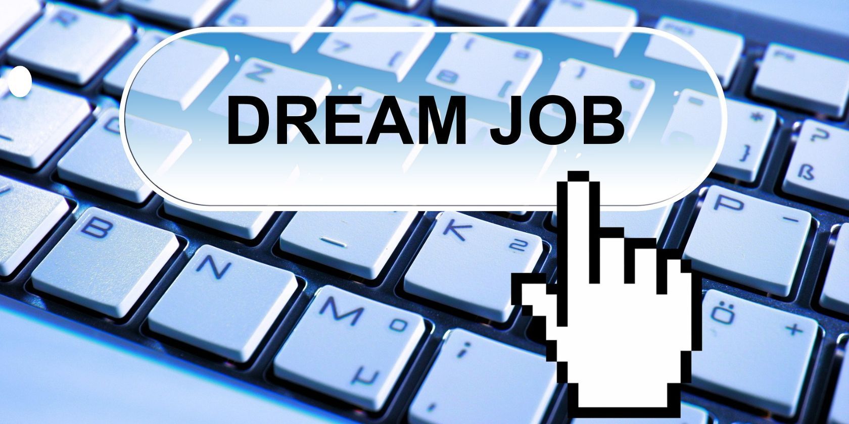 pixel image of a hand clicking "dream job" placed on the foreground of a keyboard  