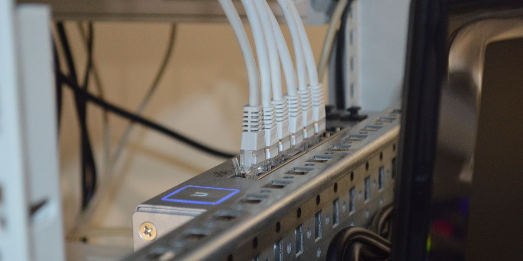 A network router with several coax cables plugged into it.