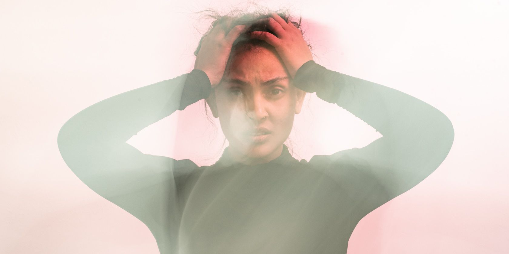 frustrated confused woman holding head experiencing anxiety panic attack