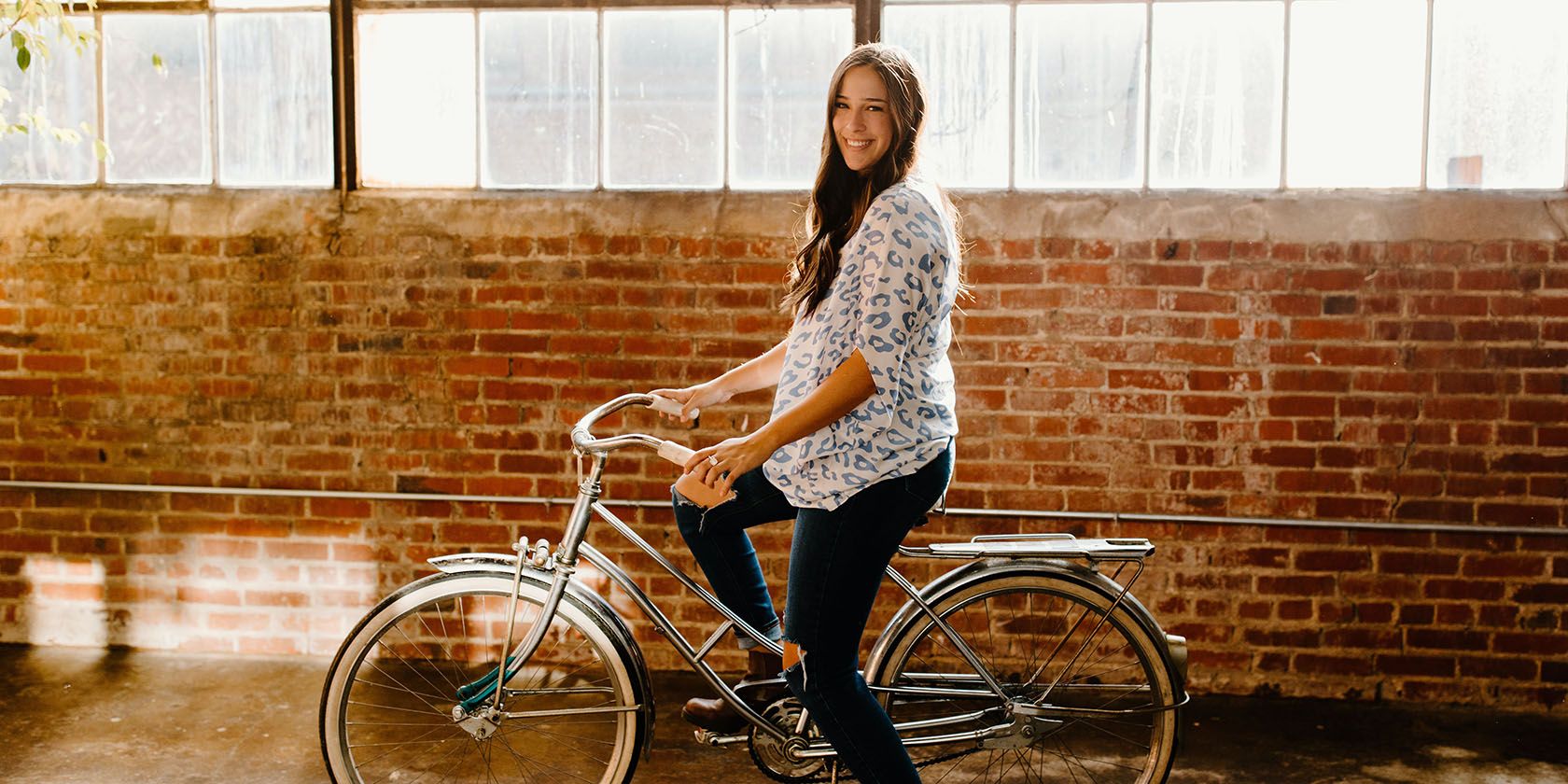 Person smiling on a bicycle