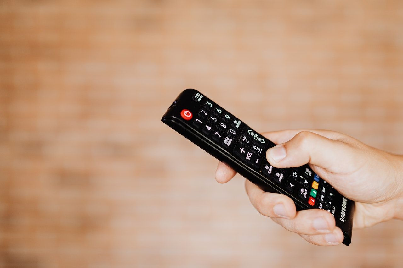 Person holding a black samsung remote control