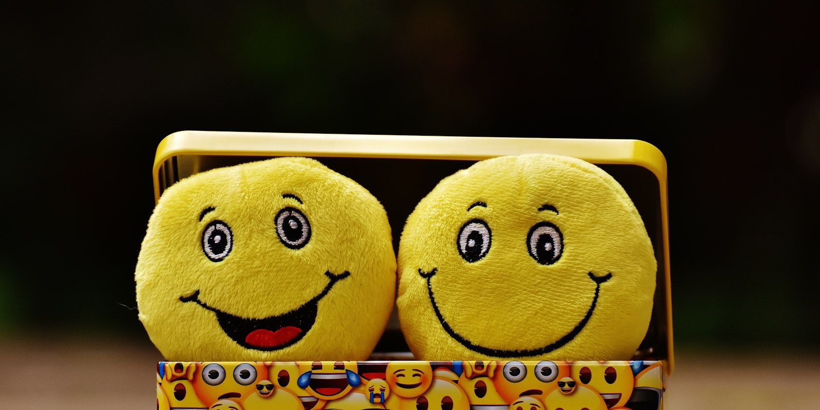 Plush happy faces in an open box