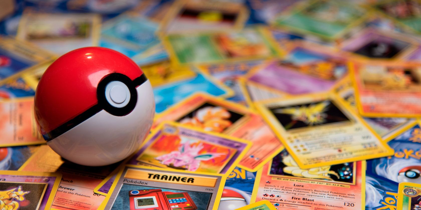 Pokeball on top of a pile of Pokemon cards photo