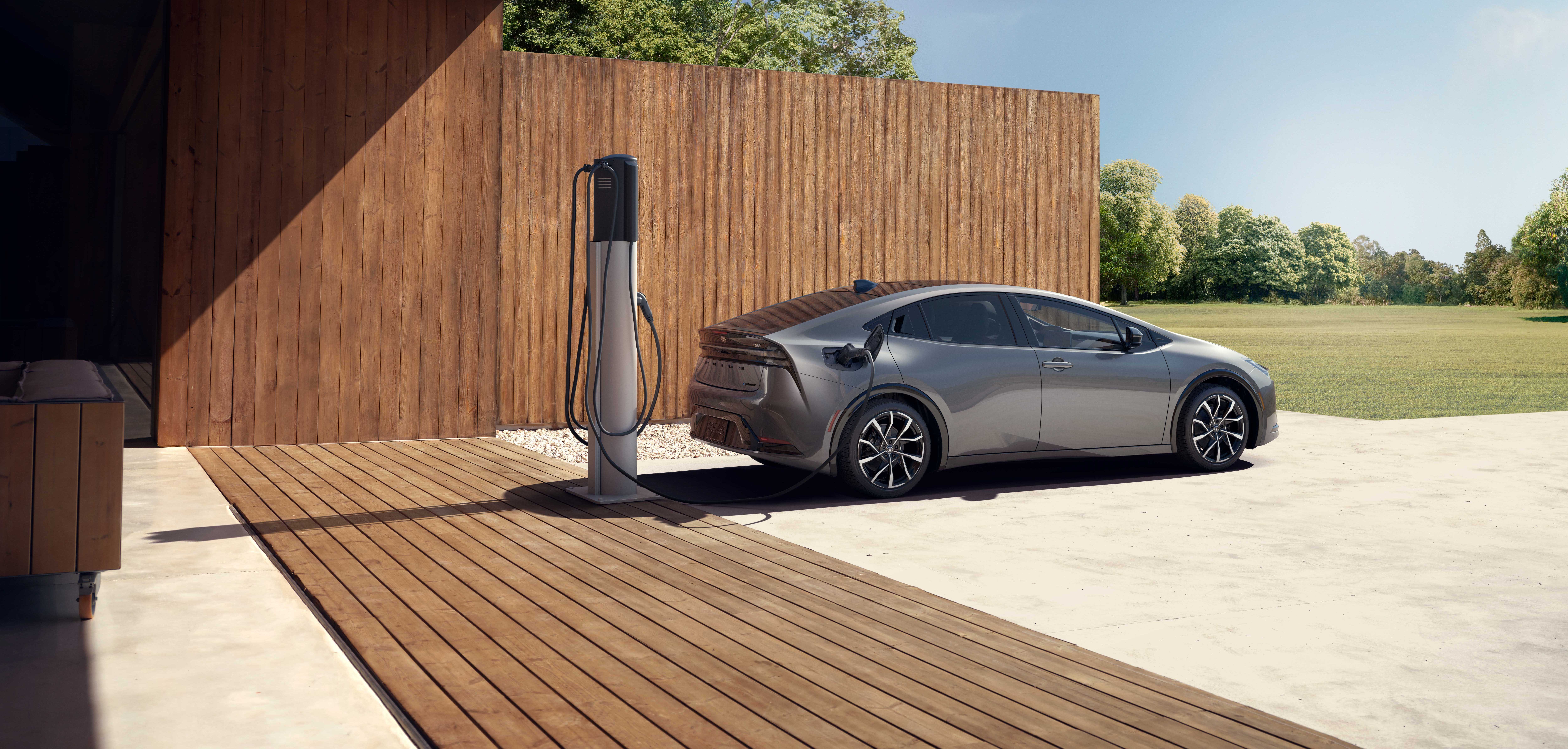 Prius Prime 2023 charging near a wood deck