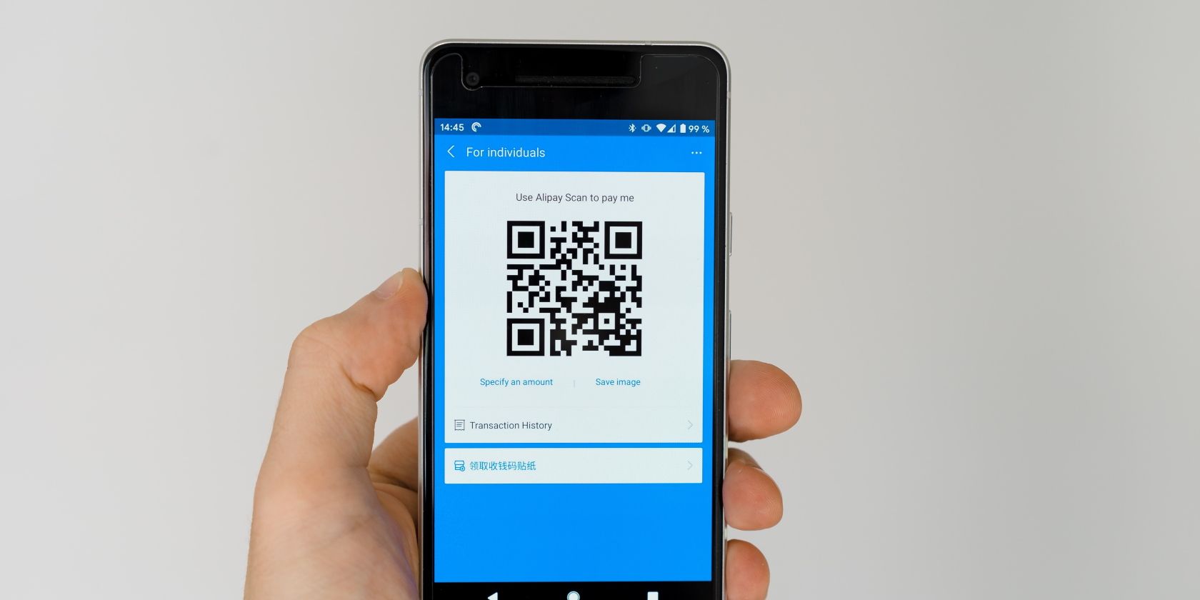 Black android smartphone displaying QR code