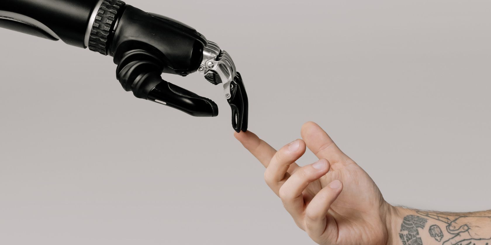robot hand and human hand touching by fingertips