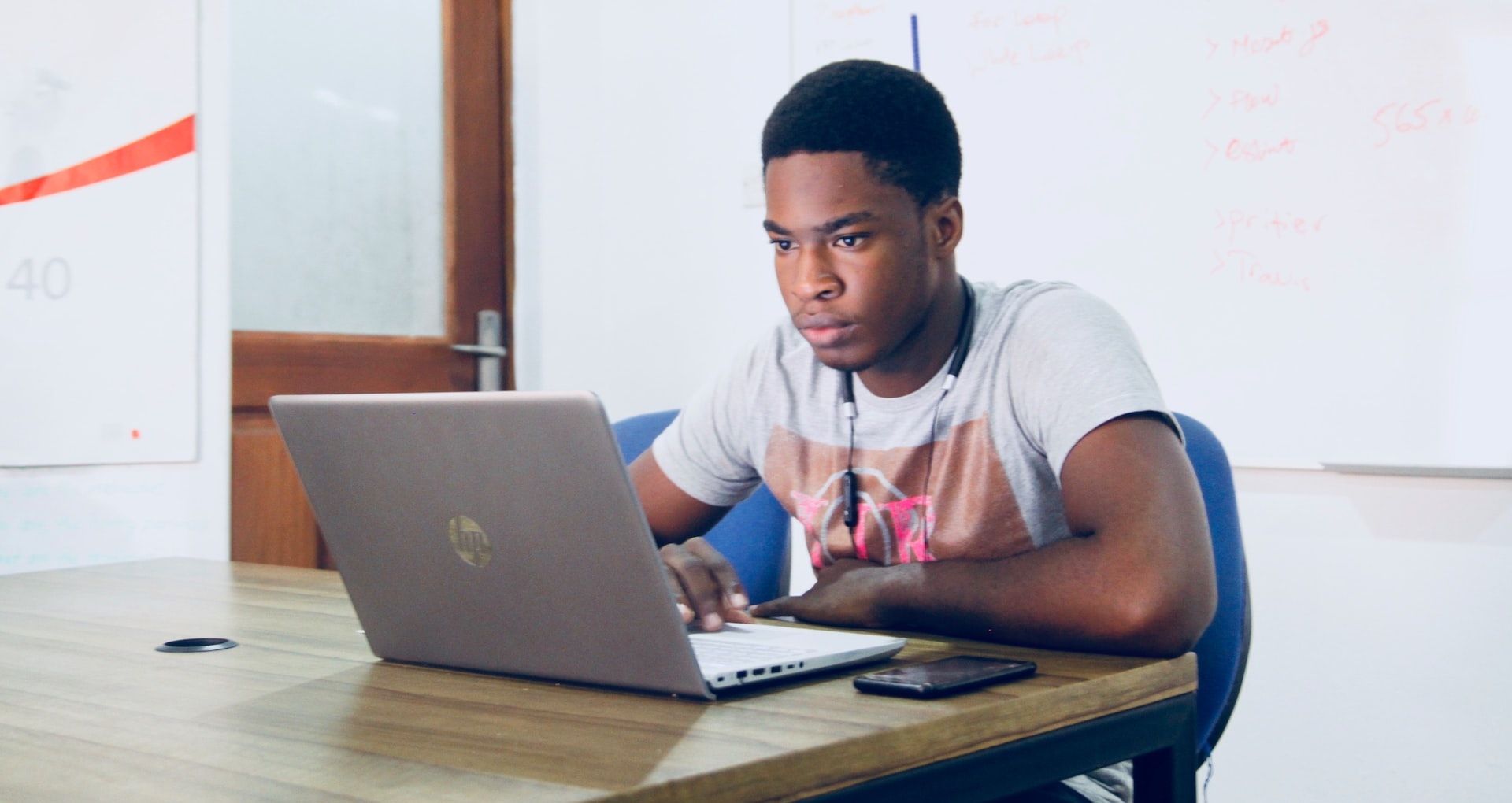 Black Boy Browsing on a Laptop
