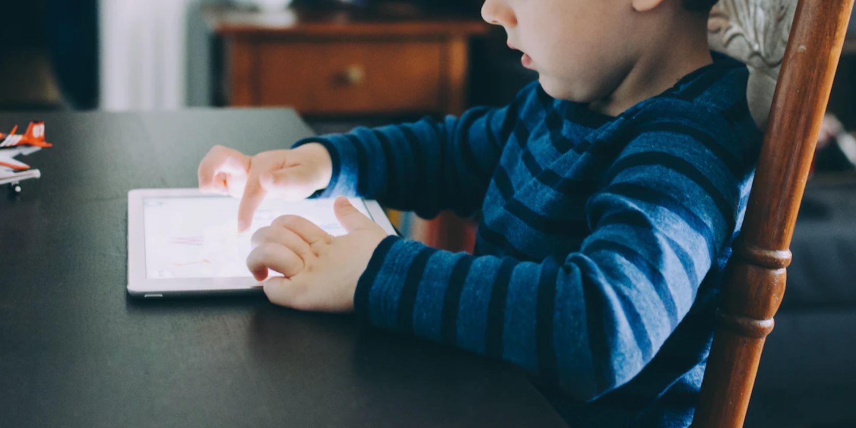 kid playing games on a tablet with touch inputs