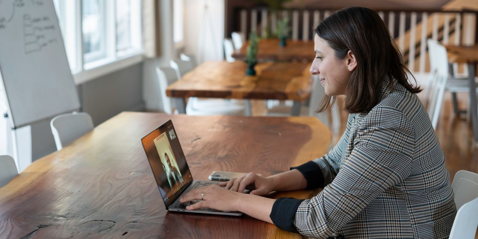 Person having a virtual meeting with a laptop on a table