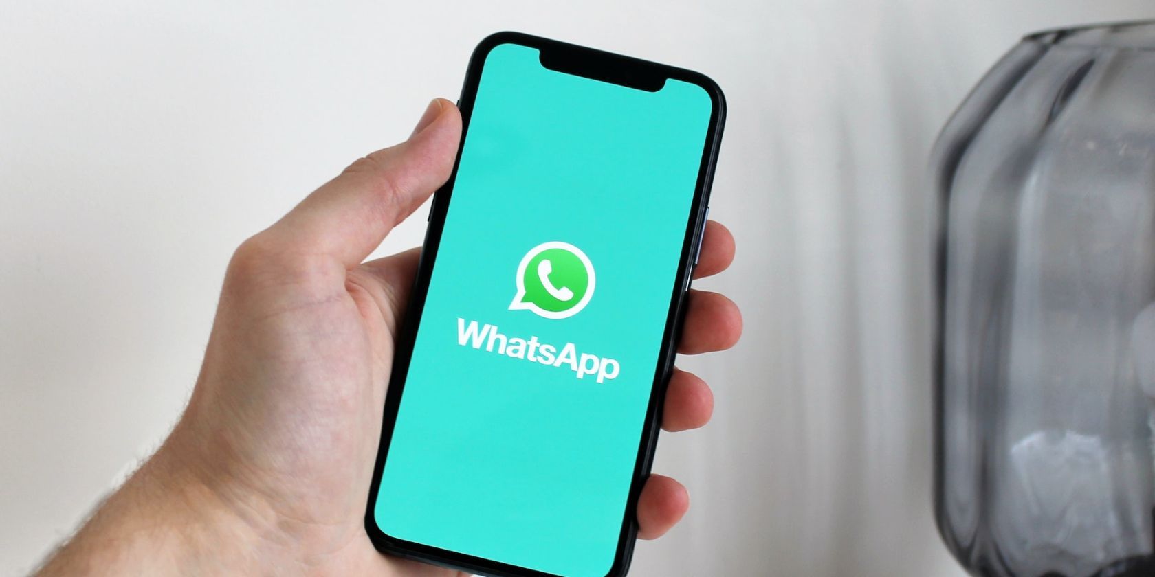WhatsApp logo on phone screen