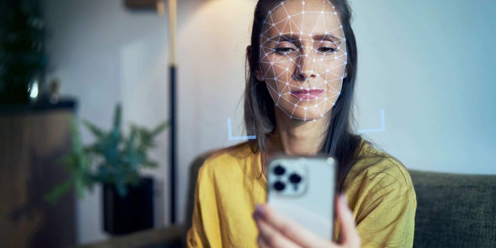 woman using facial recognition on smartphone feature