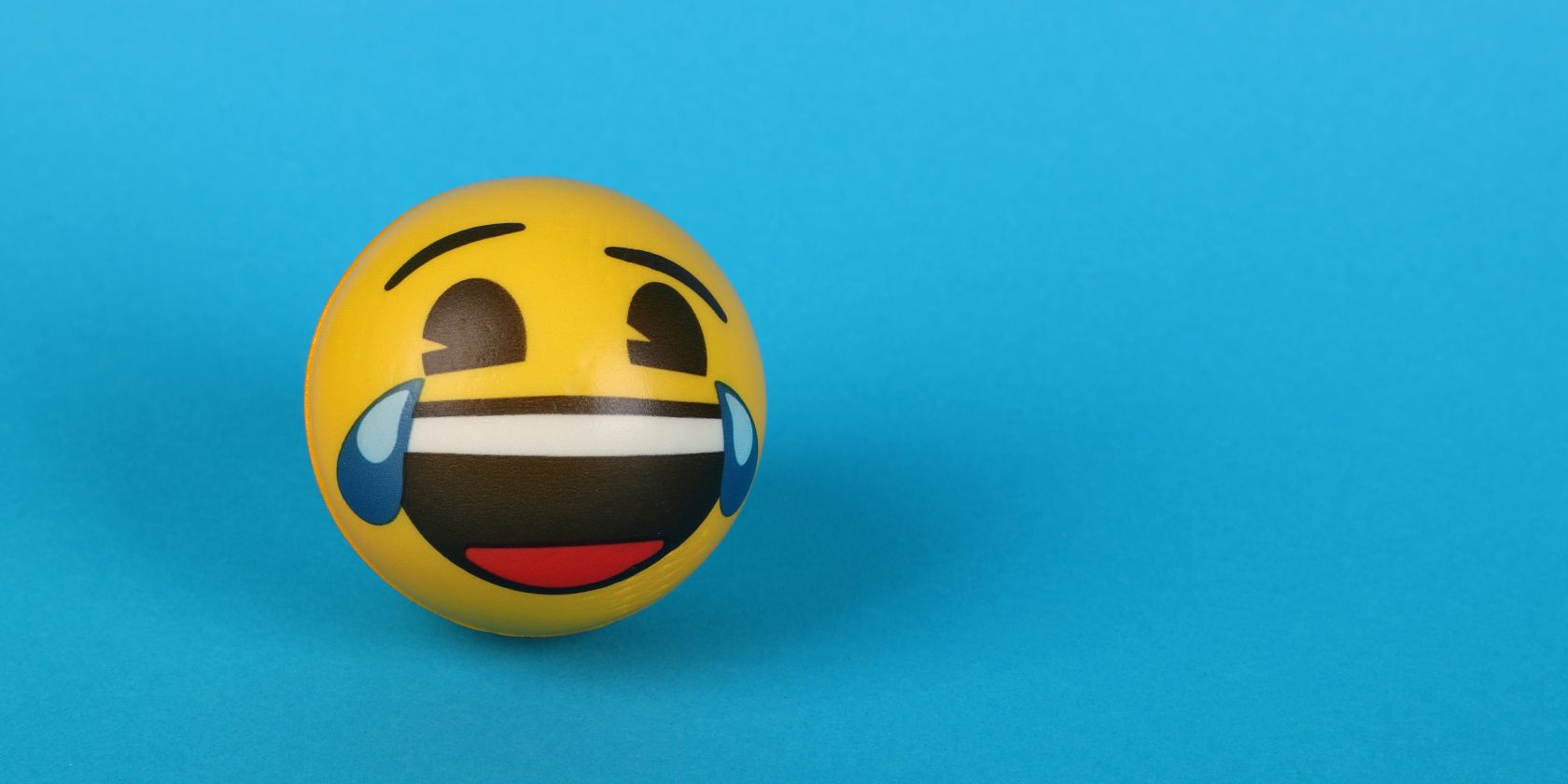 Yellow ball with laughing expression painted on